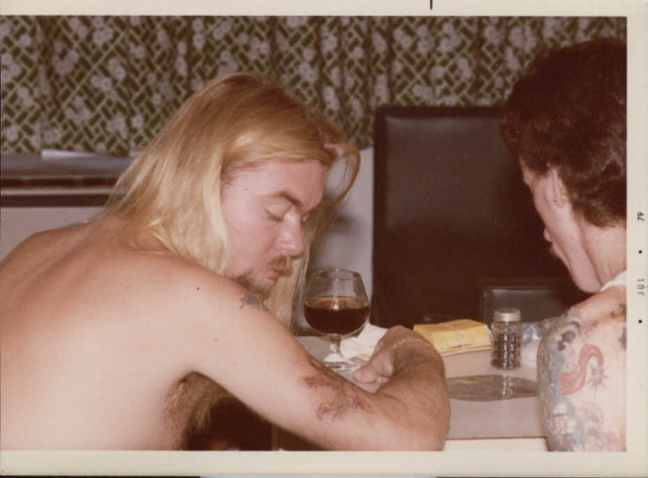 Gregg Allman Checking Out His New Tattoo In Progress. By Neil Grant 6-25-79. Minneapolis, Mn.