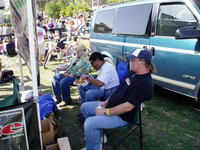 Wannee 2005. Kirk West, Oteil, and Bill Ector  relaxing behind the HTN stand.