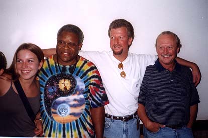 Unidentified woman with Jaimoe, Paul Riddle (of Marshall Tucker, Paul often sits in with the band on drums), and Butch.  Second photo adds Marc to the fray. Charlotte, NC, July 3, 1999
Courtesy of Michael B. Smith.