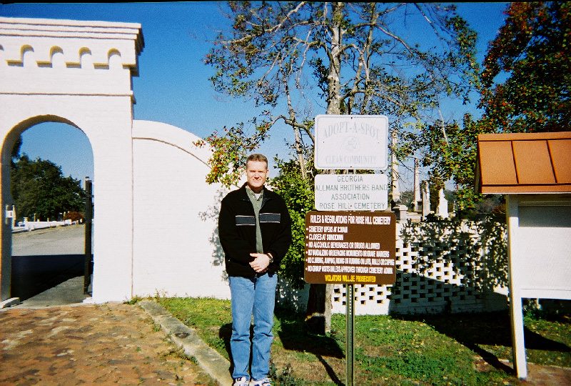 Me next to signs at entrance to Rose Hill Cemetery, Macon, GA, December 2003.