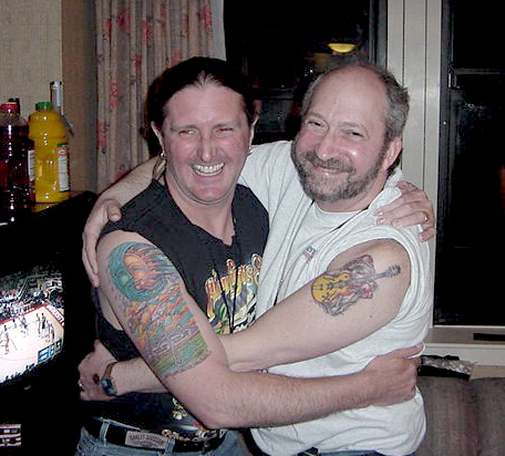 Tim and Mitch share a hug and compare their latest ink.

Beacon 3/22/03