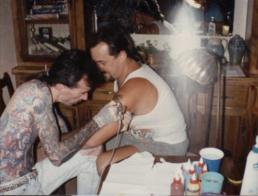 Neil Grant tattoos Frankie Toler at his home in Tennesse, 1990.